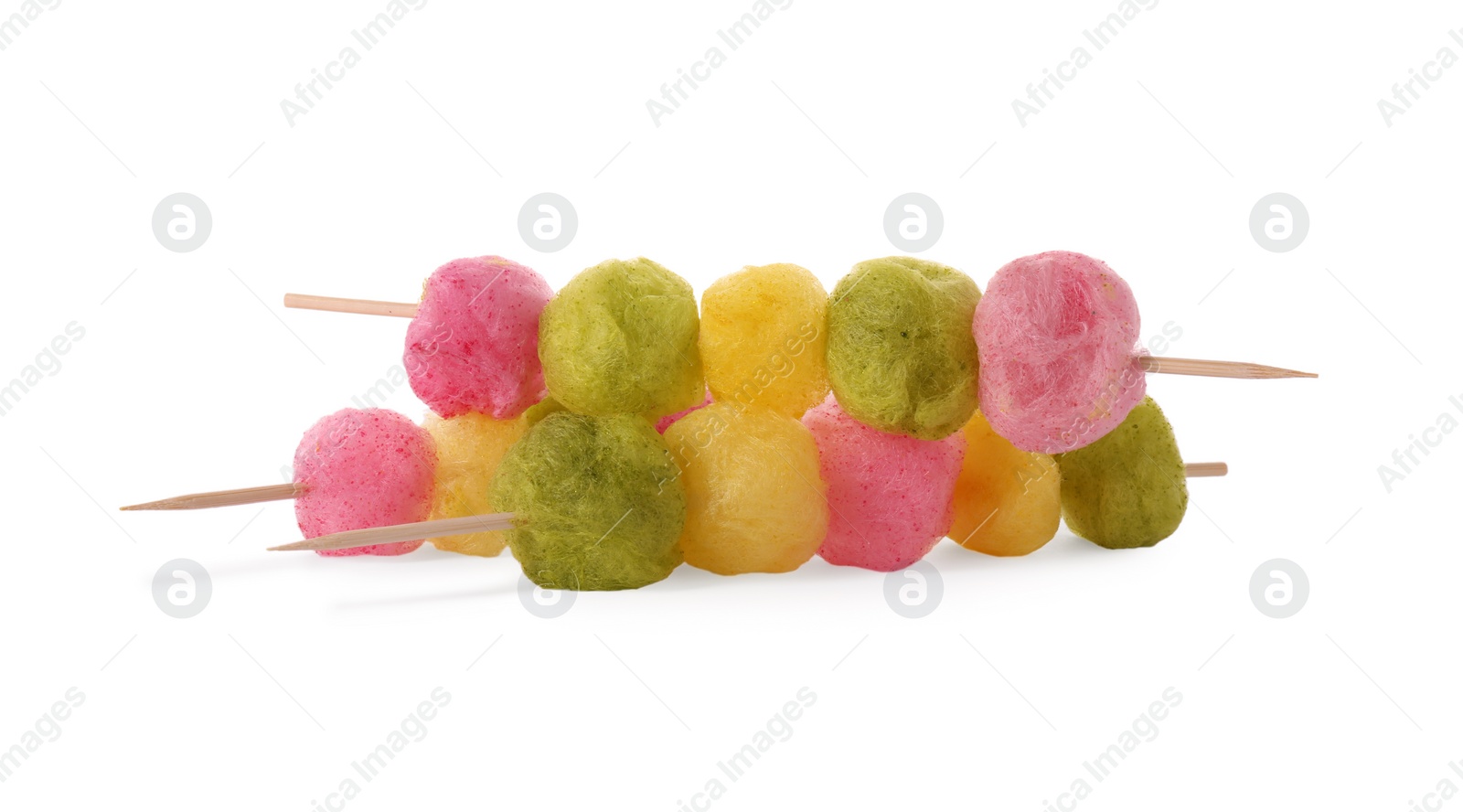 Photo of Skewers with color cotton balls isolated on white. Sweet candy