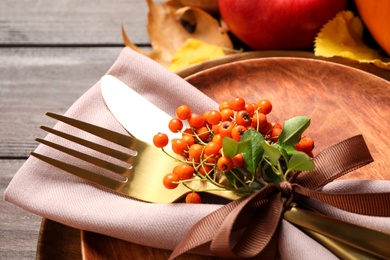 Table setting with rowan berries on wooden background, closeup. Thanksgiving Day