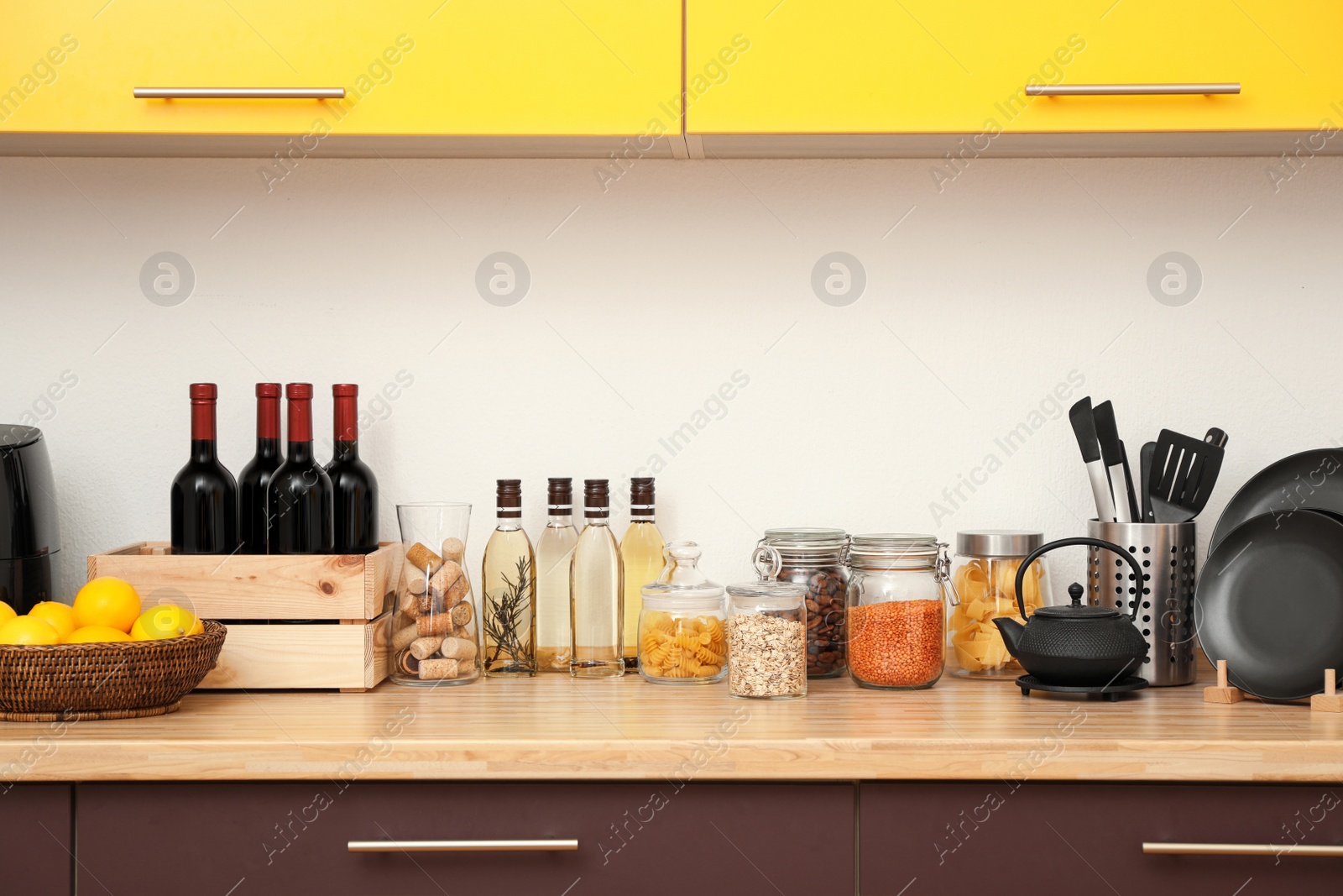 Photo of Stylish kitchen interior with wooden countertop and wall cabinets