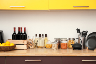 Photo of Stylish kitchen interior with wooden countertop and wall cabinets