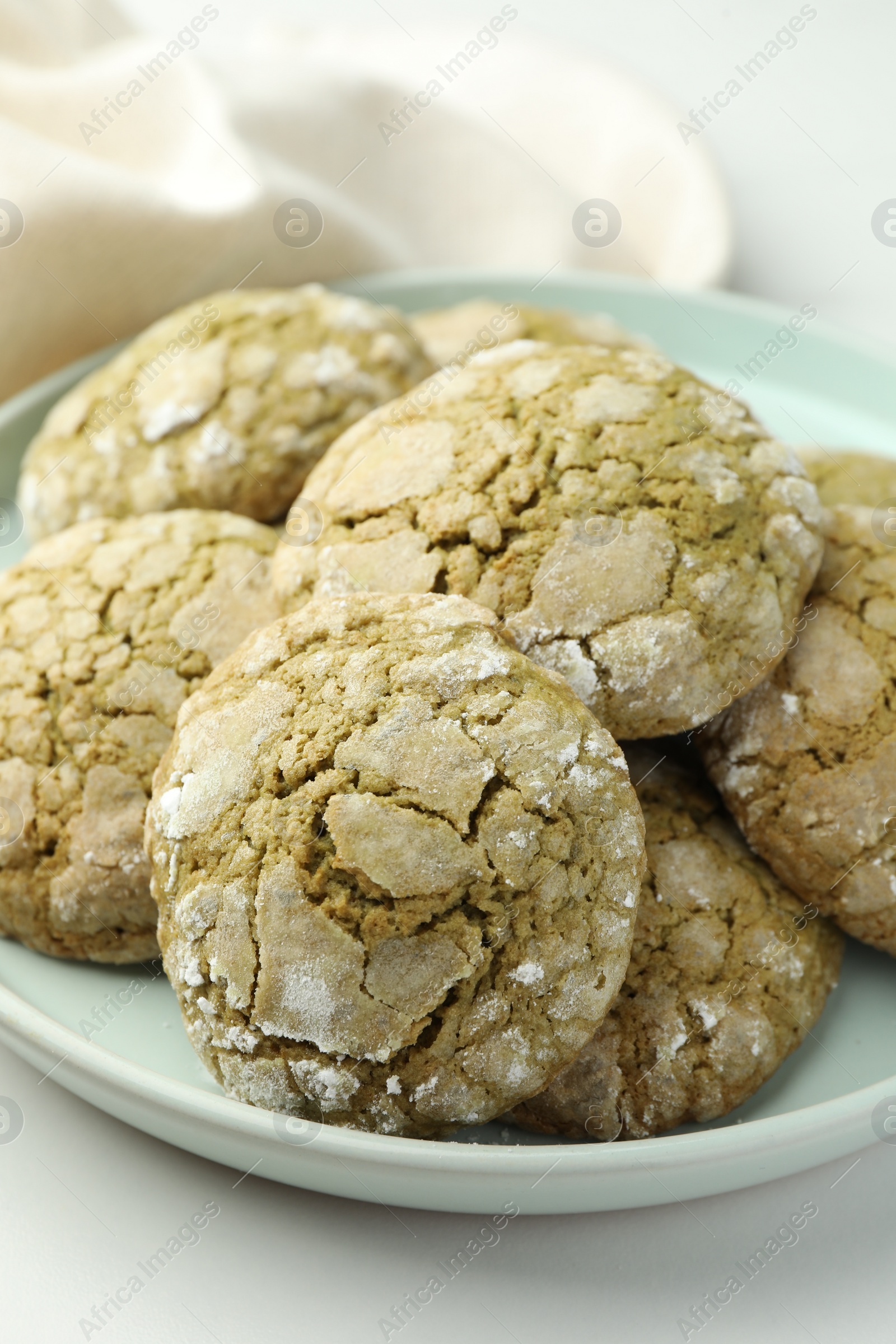 Photo of Plate with tasty matcha cookies on white table, closeup