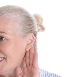 Photo of Mature woman with hearing problem on white background, closeup