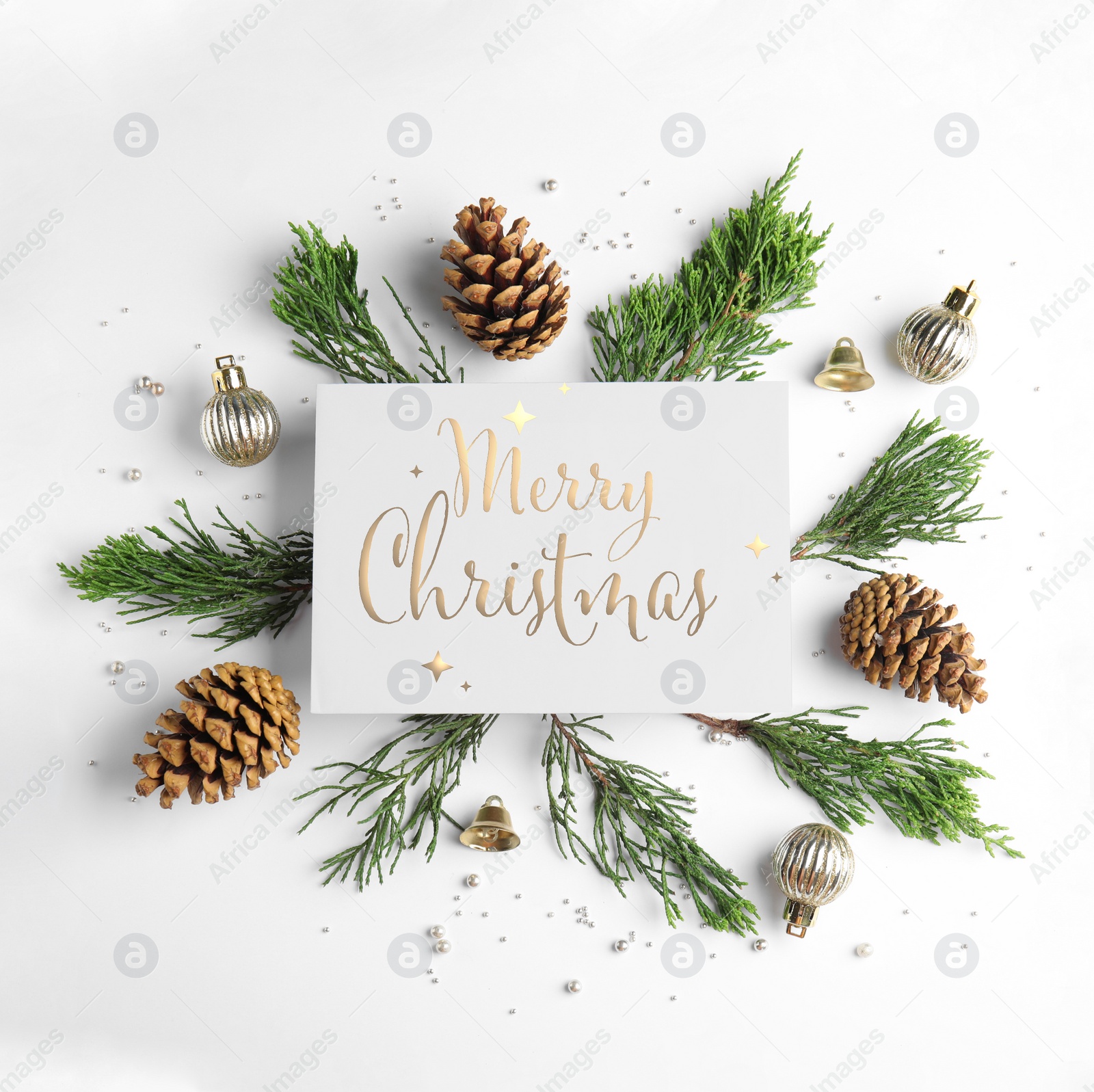 Image of Flat lay composition with text MERRY CHRISTMAS and festive decor on white background