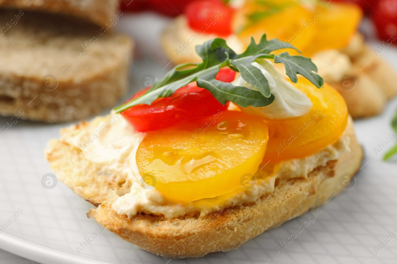 Photo of Delicious tomato bruschetta on plate, closeup. Traditional Italian antipasto