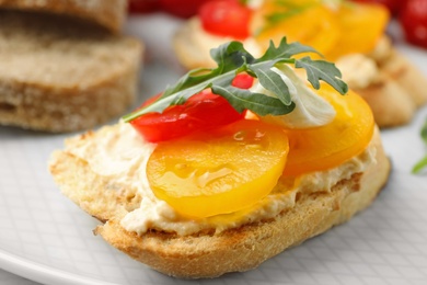 Delicious tomato bruschetta on plate, closeup. Traditional Italian antipasto