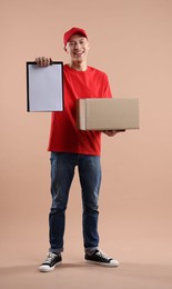 Photo of Happy courier with parcel on beige background