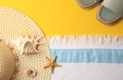 Photo of Flat lay composition with beach accessories on yellow background, space for text