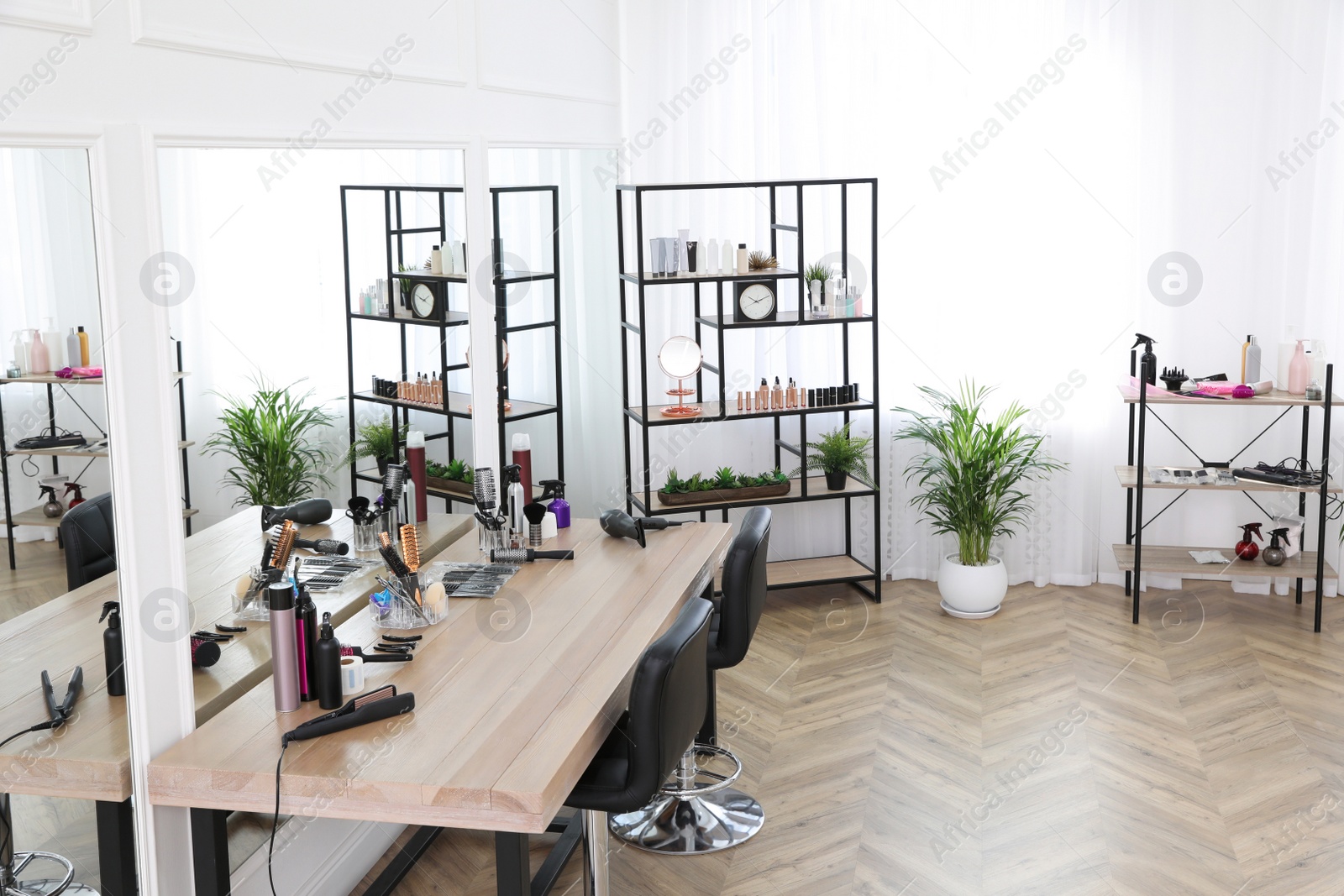 Photo of Stylish beauty salon interior with hairdresser's workplace