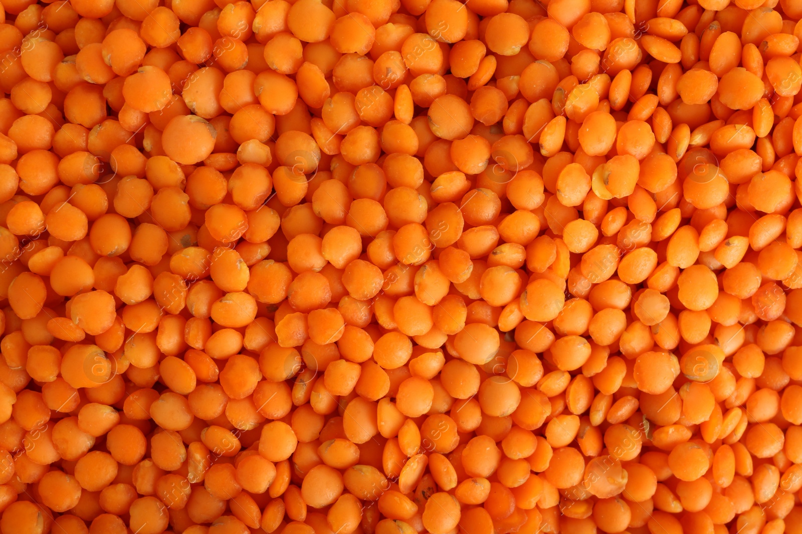 Photo of Organic red lentils as background, top view