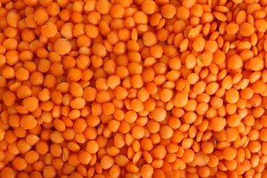 Organic red lentils as background, top view