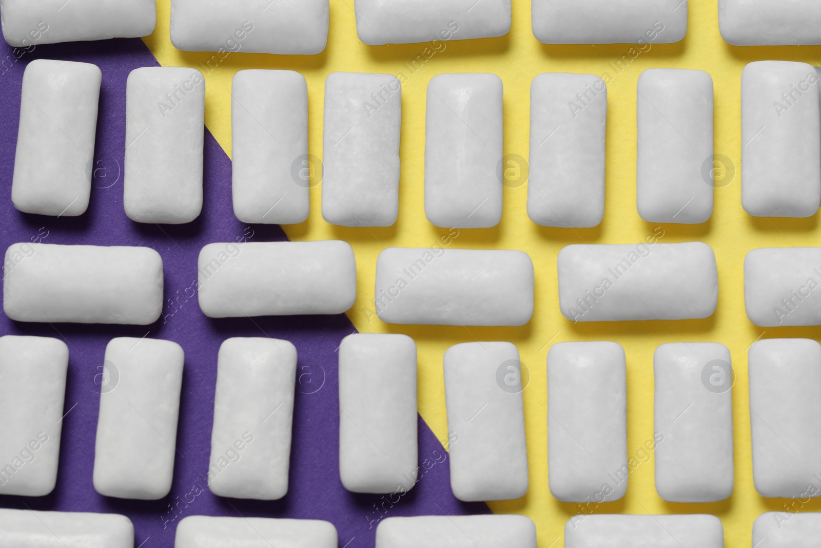 Photo of Tasty white chewing gums on color background, flat lay