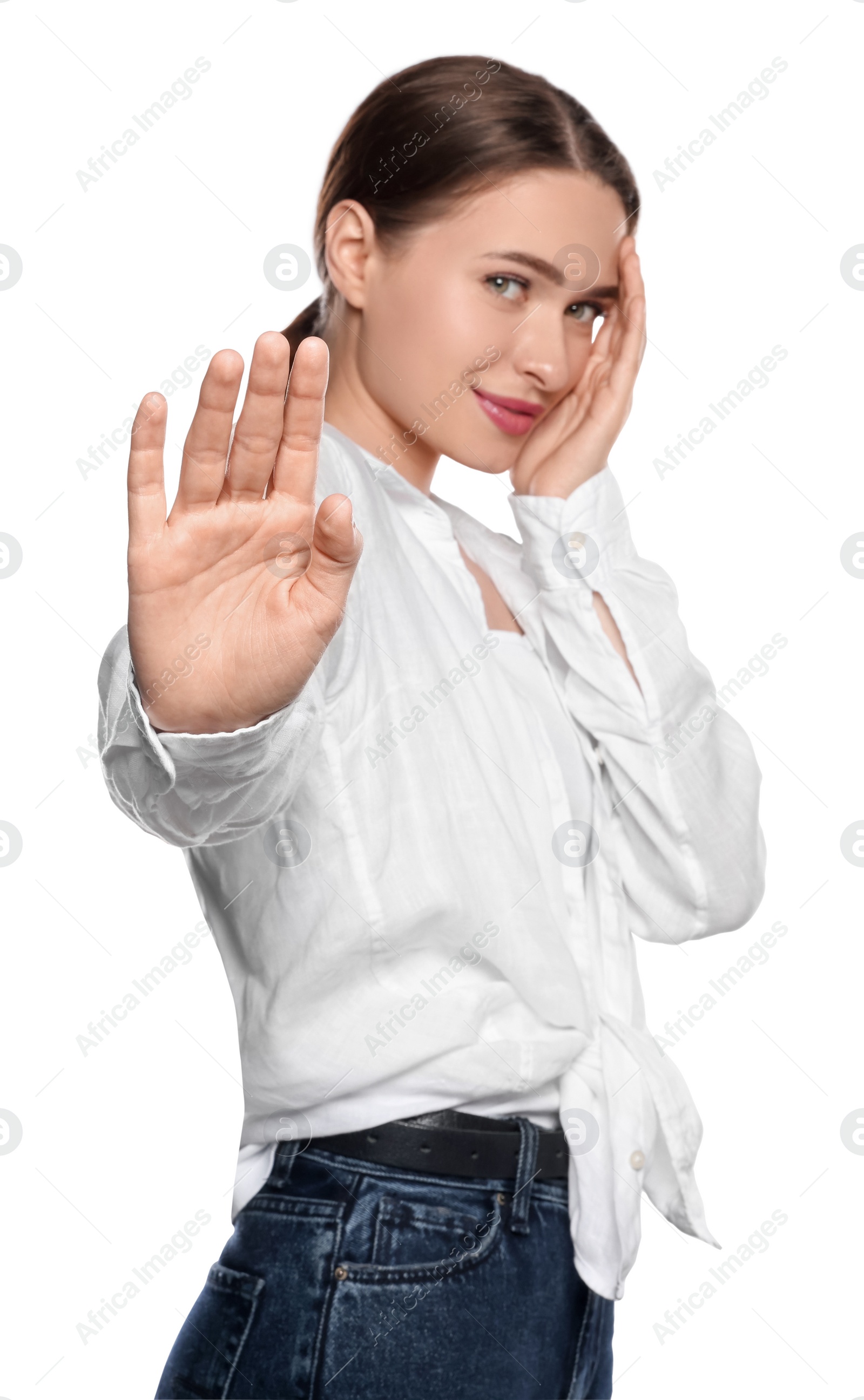 Photo of Embarrassed young woman covering face with hand on white background