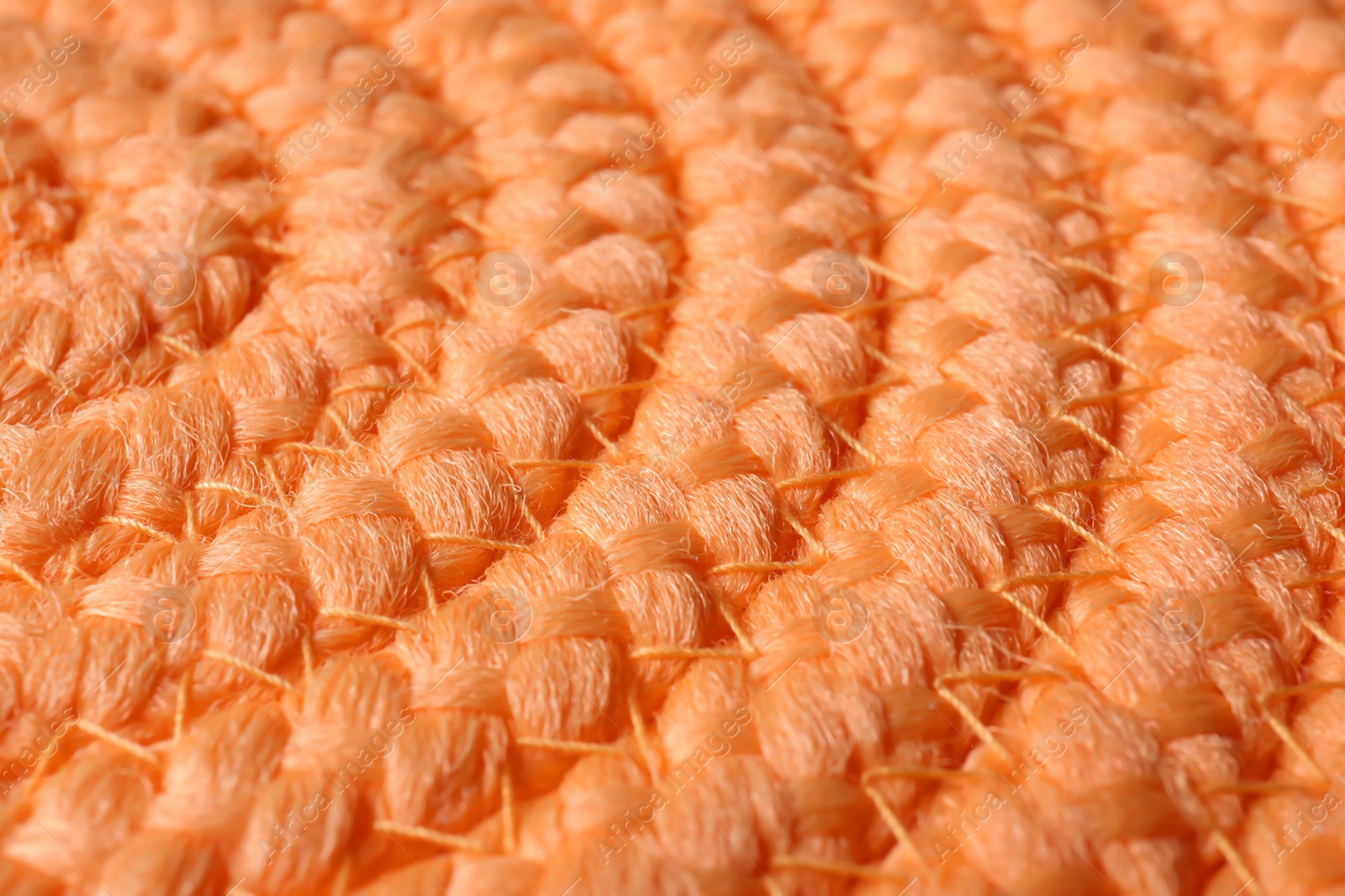 Photo of Orange wicker mat texture as background, closeup