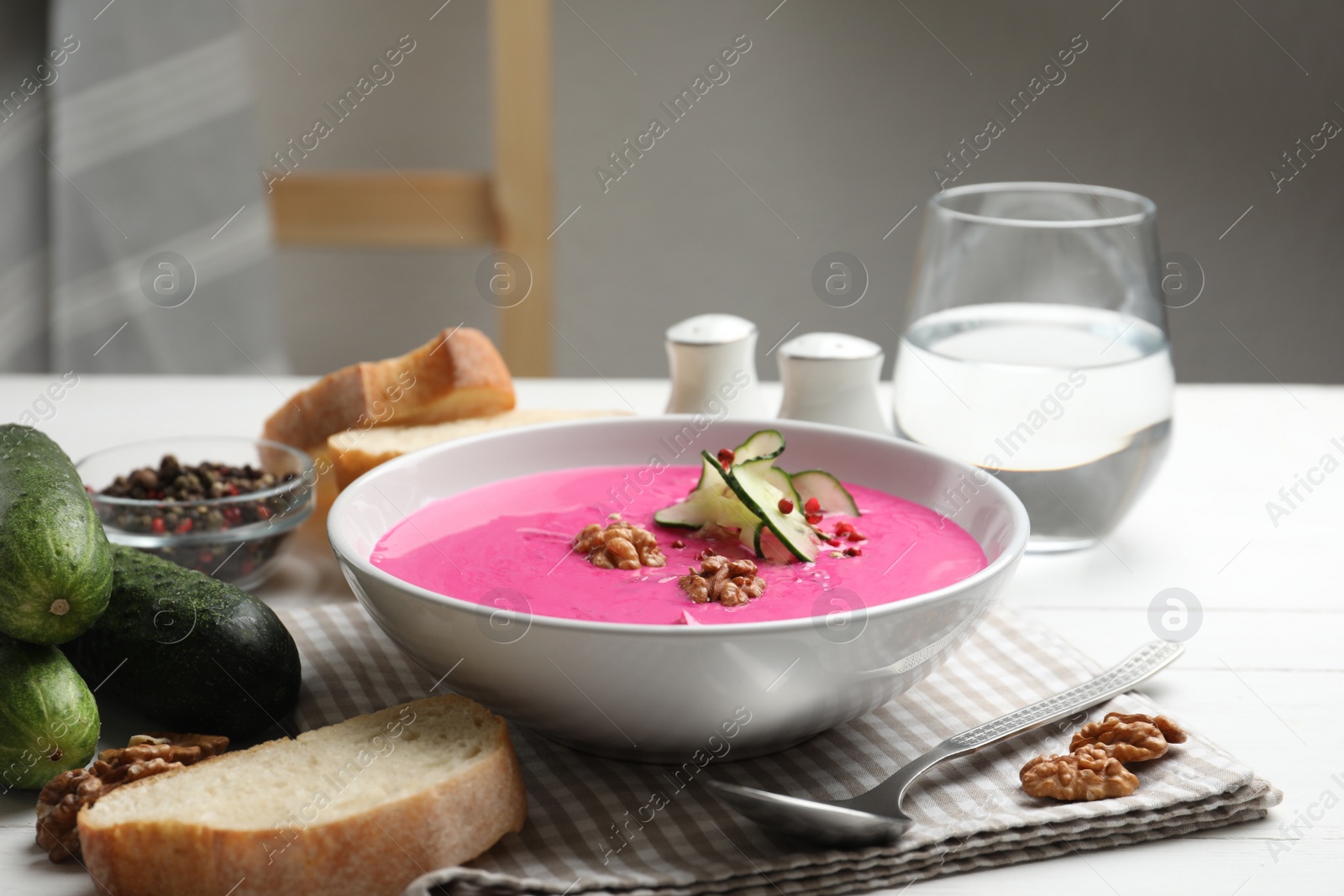 Photo of Delicious cold summer beet soup on white wooden table