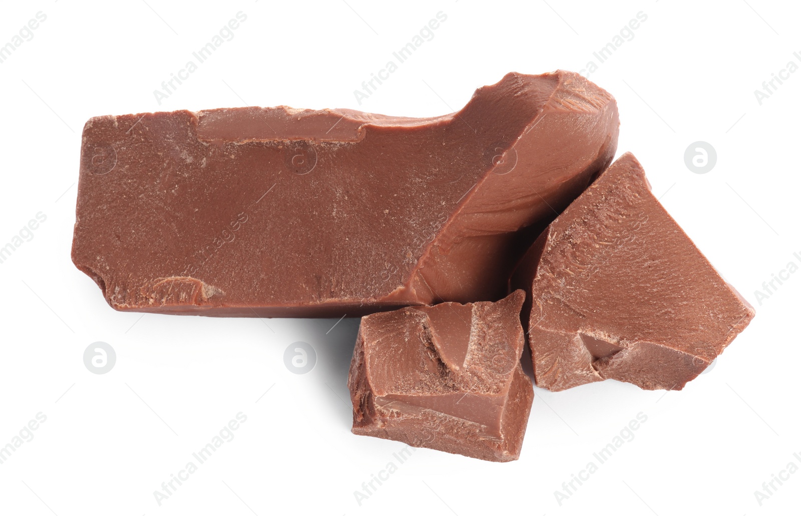 Photo of Pieces of tasty milk chocolate isolated on white, top view