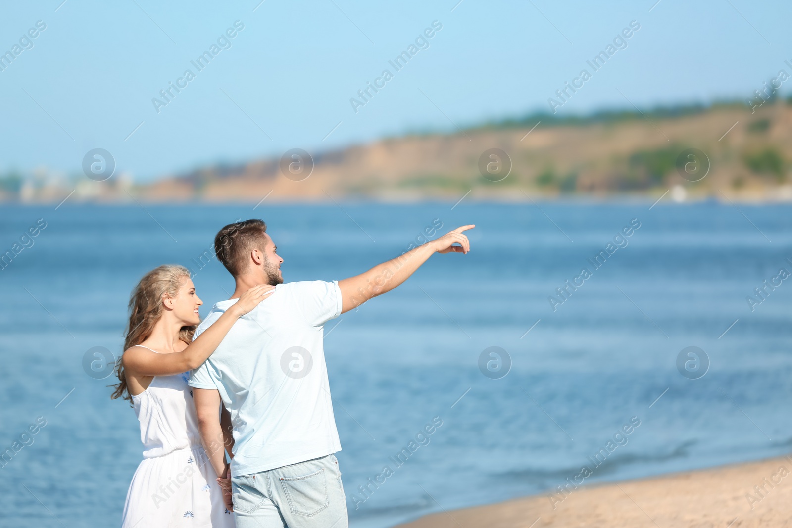 Photo of Happy young couple at beach on sunny day