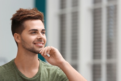 Photo of Portrait of handsome young man in room. Space for text