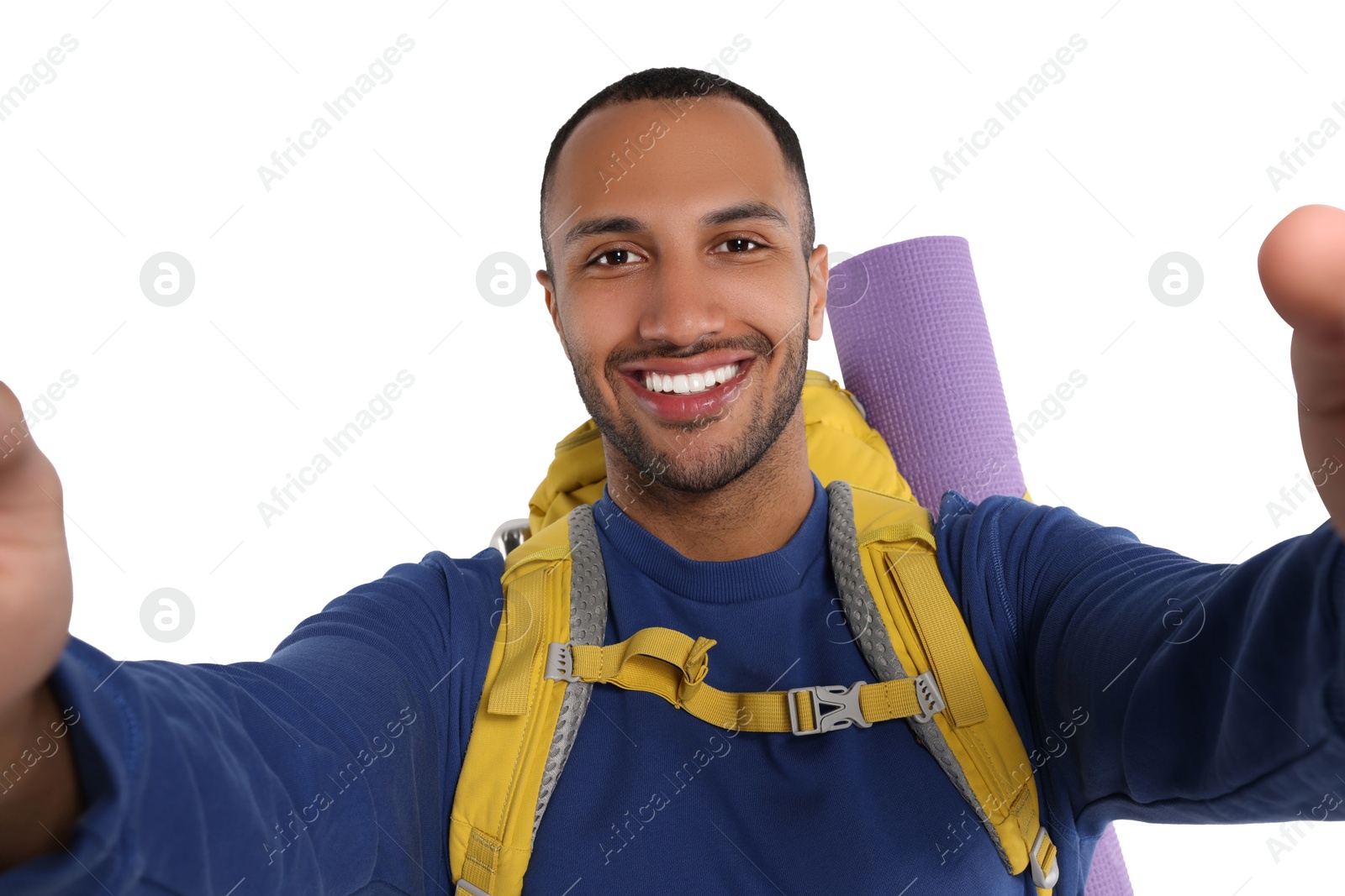 Photo of Happy tourist with backpack taking selfie on white background