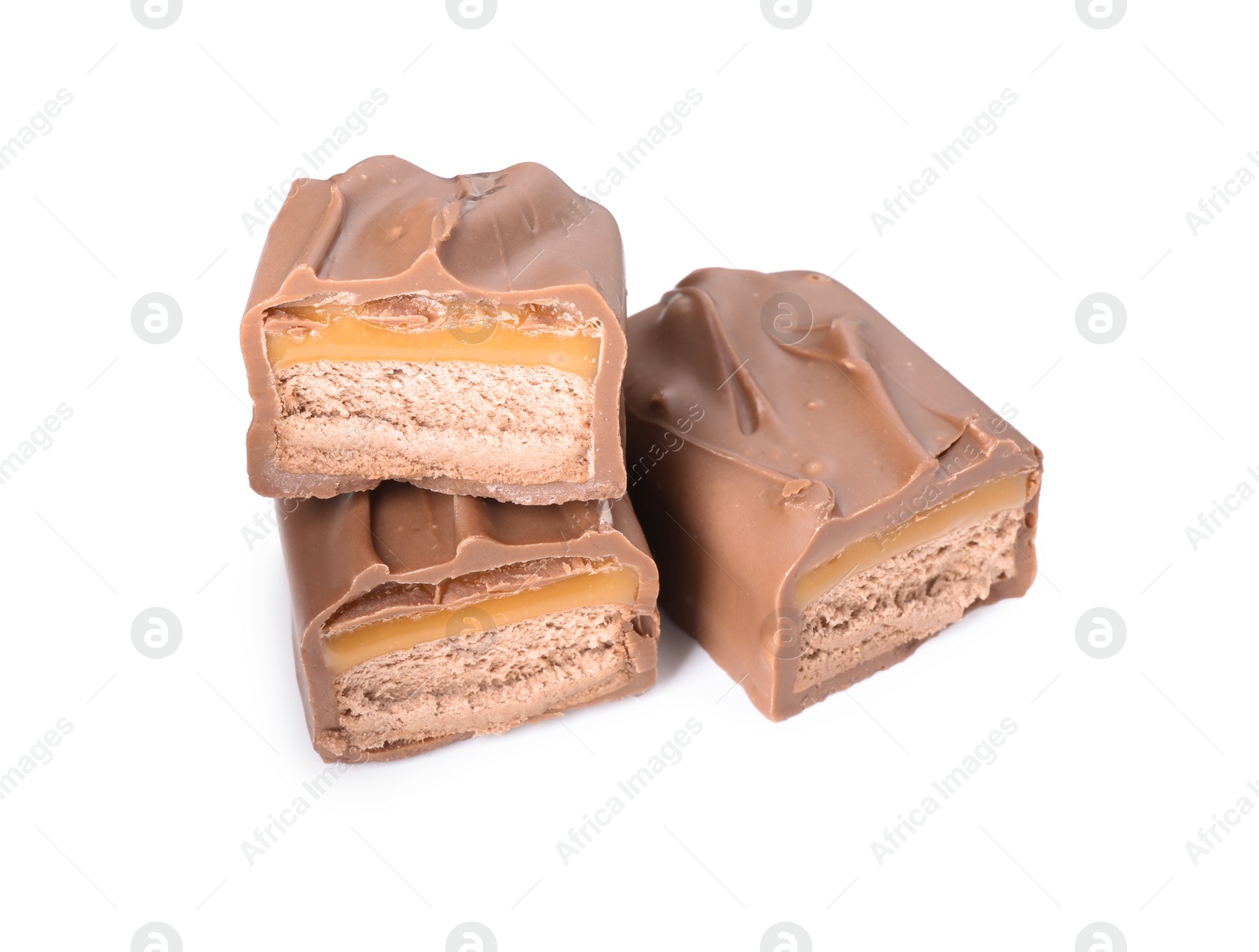 Photo of Pieces of tasty chocolate bars with nougat on white background