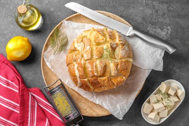 Freshly baked bread with tofu cheese served on grey table, flat lay