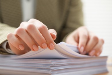 Photo of Woman working with documents in office, closeup view