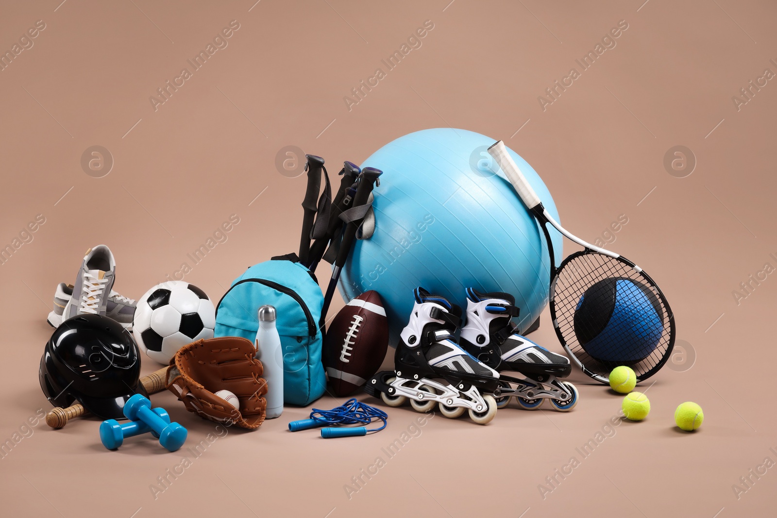 Photo of Many different sports equipment on beige background