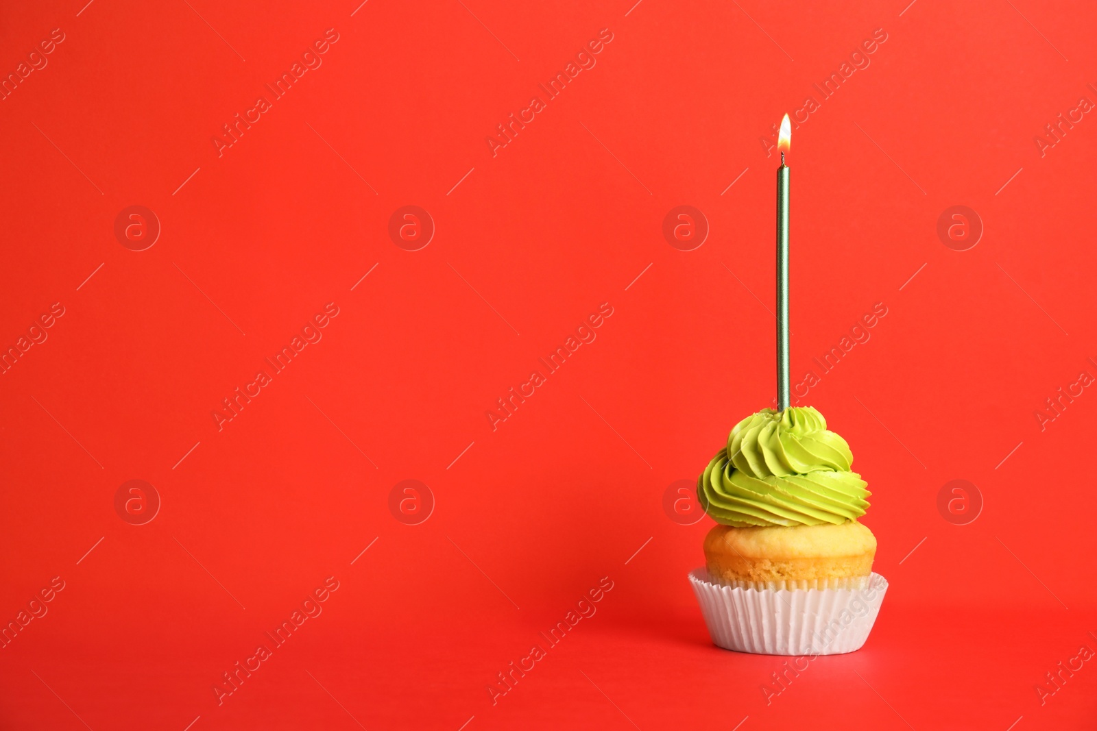 Photo of Birthday cupcake with candle on red background, space for text