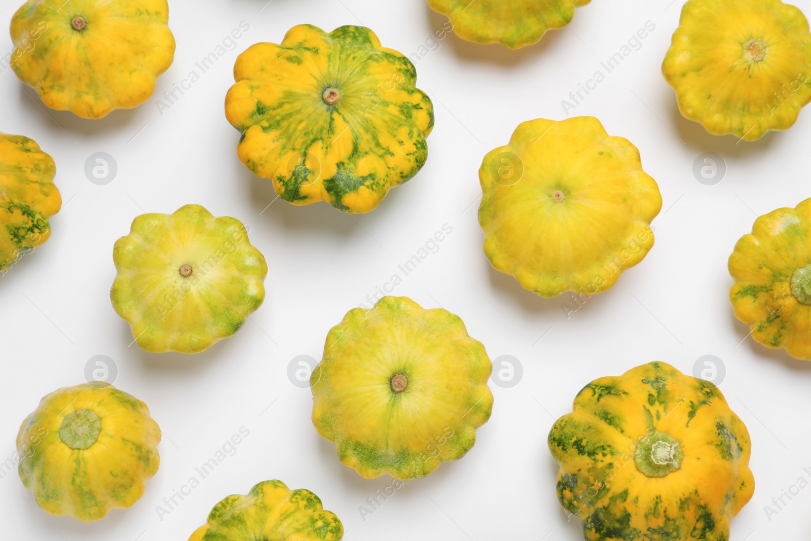 Photo of Fresh ripe pattypan squashes on white background, top view