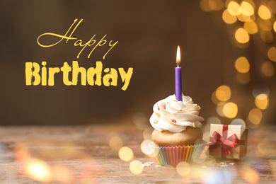 Image of Delicious cupcake and gift box on wooden table against blurred lights. Happy Birthday