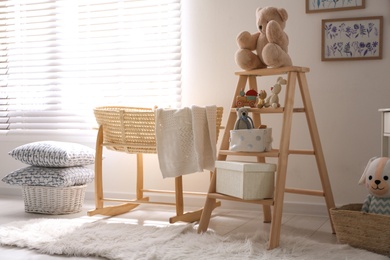 Photo of Decorative ladder with toys and different stuff in stylish baby room. Idea for interior design