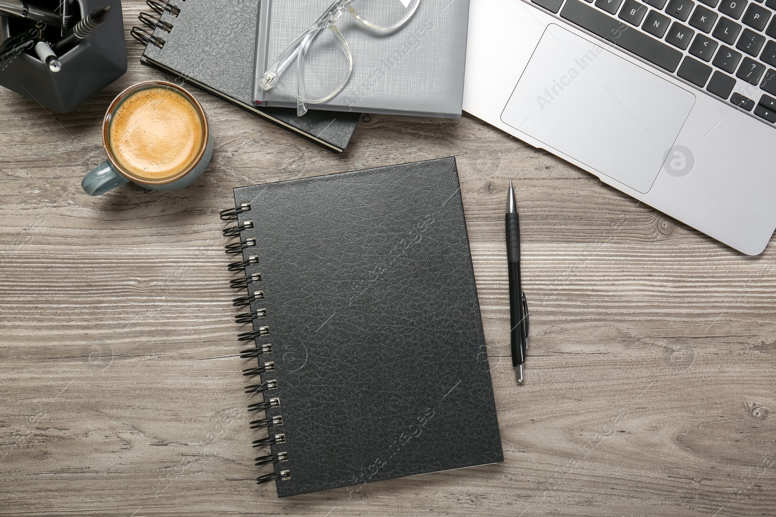 Photo of Flat lay composition with notebooks and laptop on wooden table