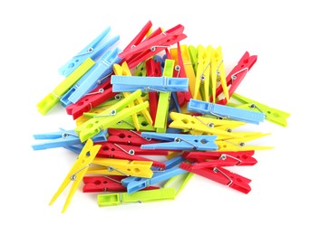 Colorful plastic clothespins on white background, top view