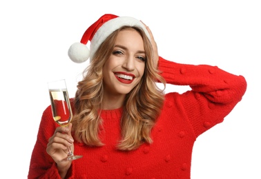 Photo of Happy young woman wearing Santa hat with glass of champagne on white background. Christmas celebration