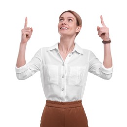 Photo of Beautiful happy businesswoman pointing at something on white background