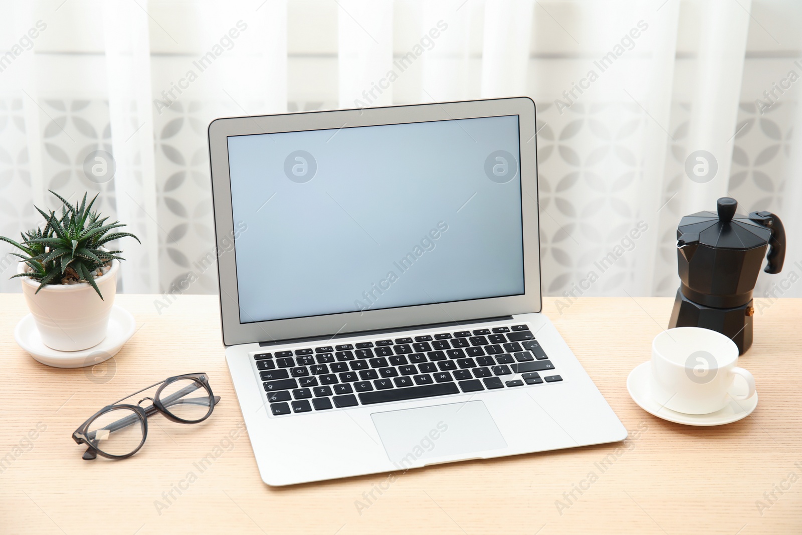 Photo of Cozy blogger workplace with laptop at home