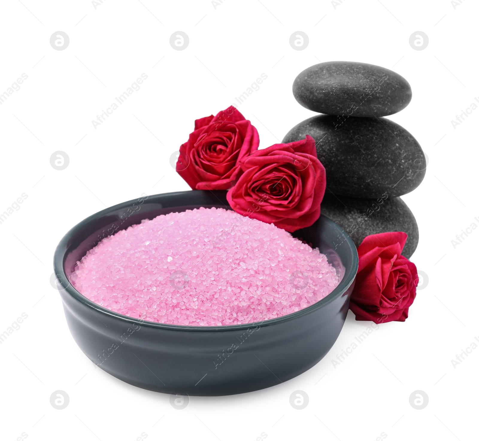 Photo of Pink sea salt in bowl, roses and spa stones isolated on white