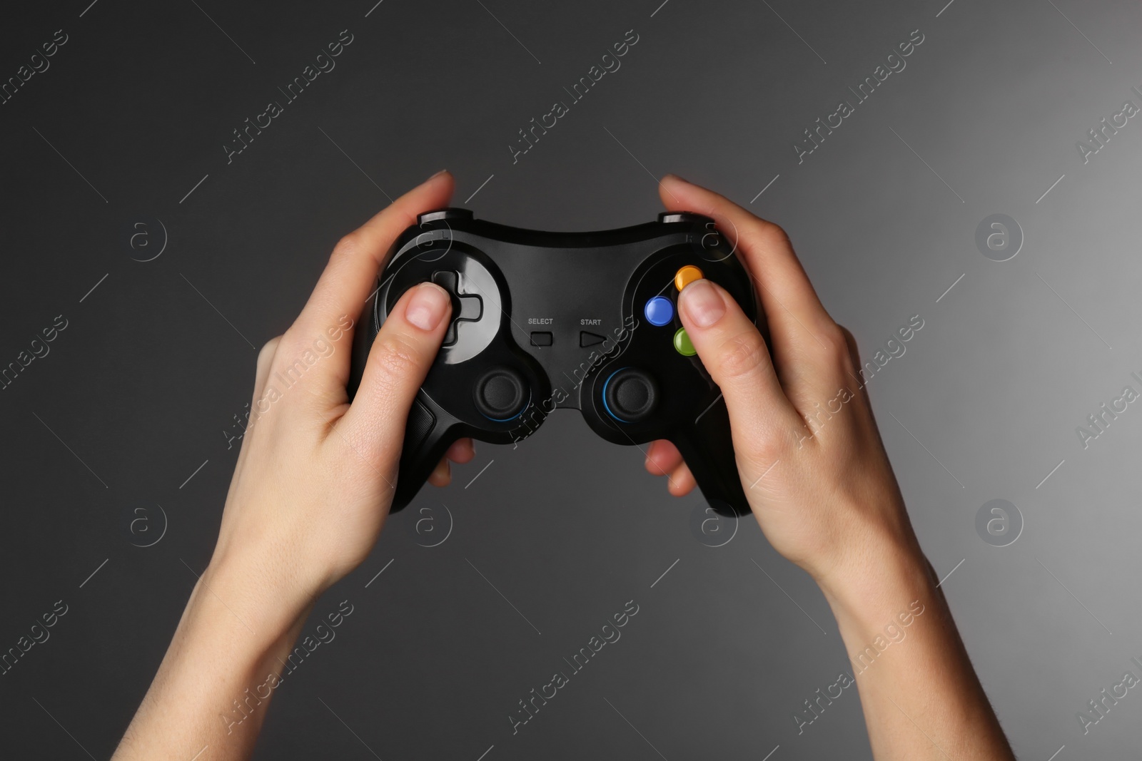 Photo of Woman with game controller on grey background, closeup