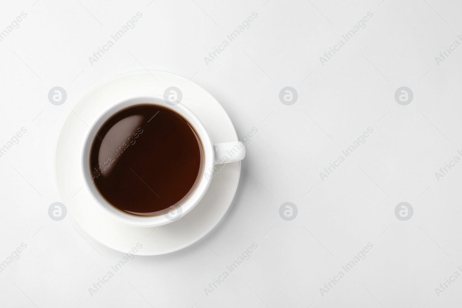 Photo of Ceramic cup with hot aromatic coffee on white background