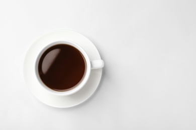 Photo of Ceramic cup with hot aromatic coffee on white background