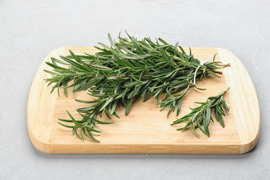 Bunch of fresh rosemary on light grey table