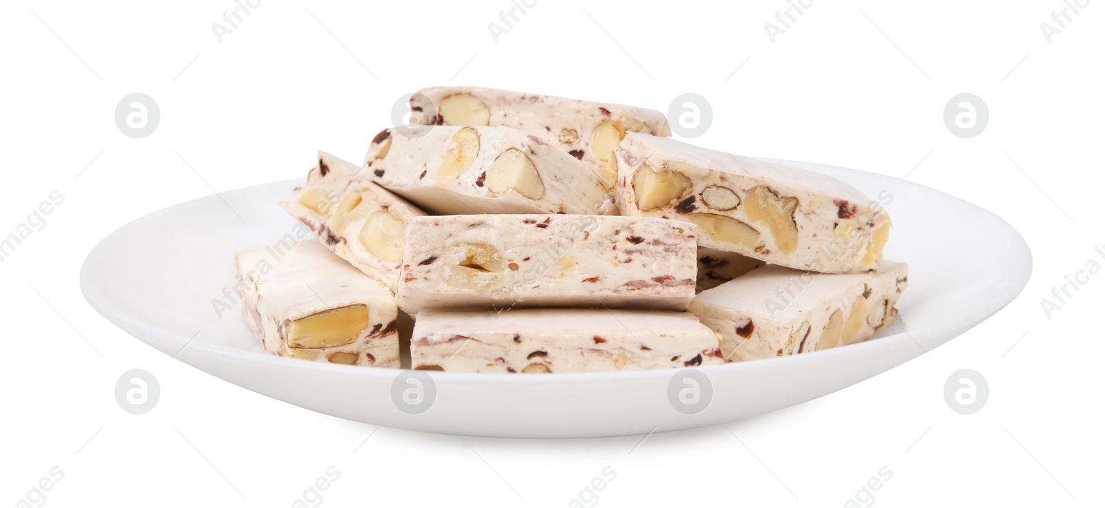 Photo of Plate with pieces of delicious nougat isolated on white