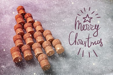 Image of Christmas tree made of sparkling wine corks on grey table