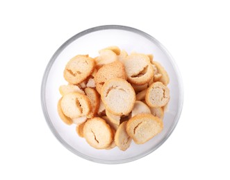 Delicious crispy rusks in glass bowl on white background, top view
