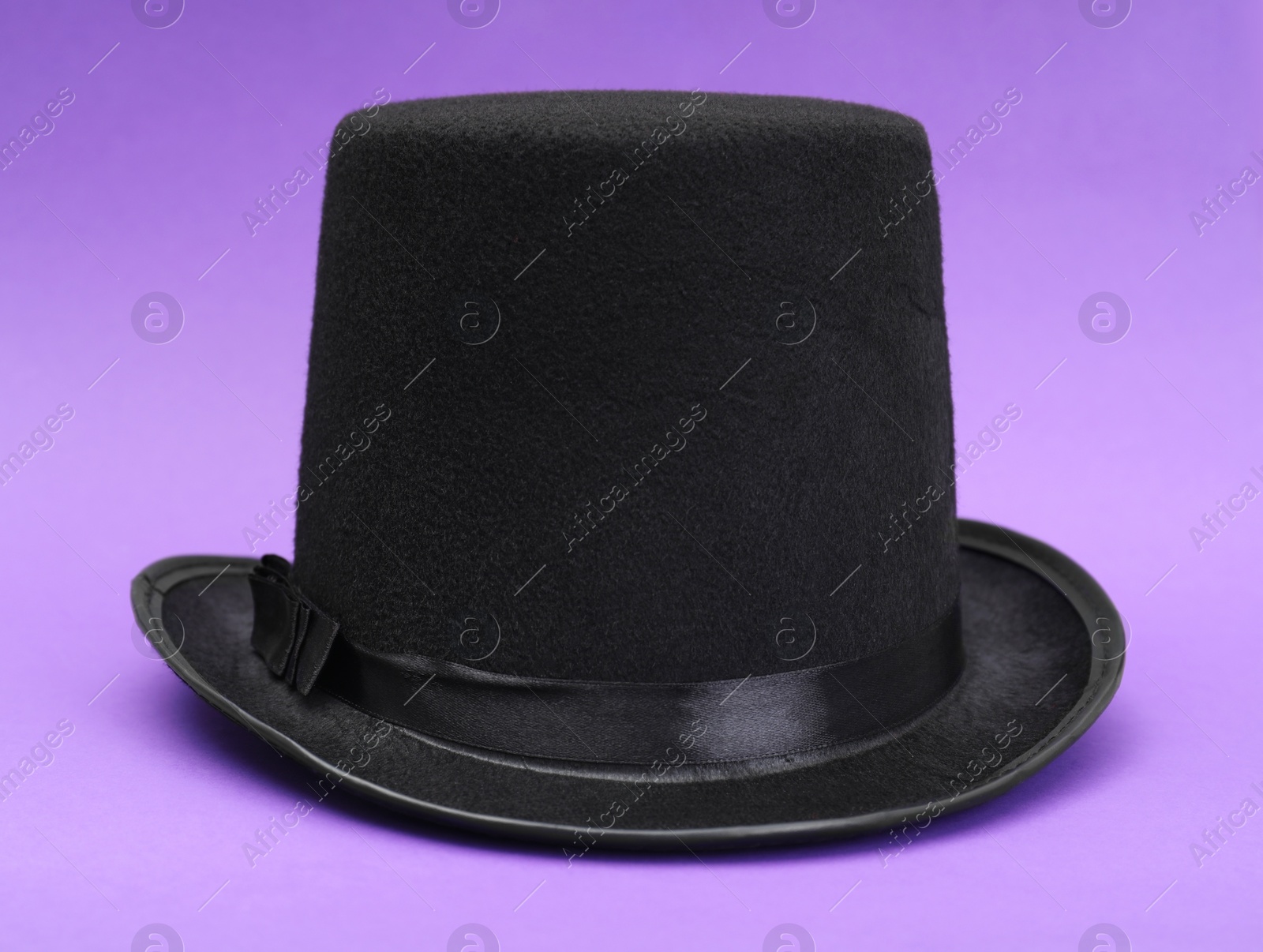 Photo of One magician top hat on violet background