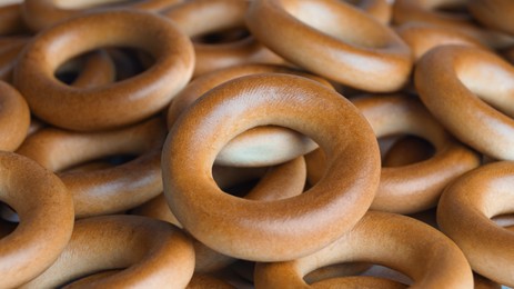 Photo of Tasty dry bagels (sushki) as background, closeup