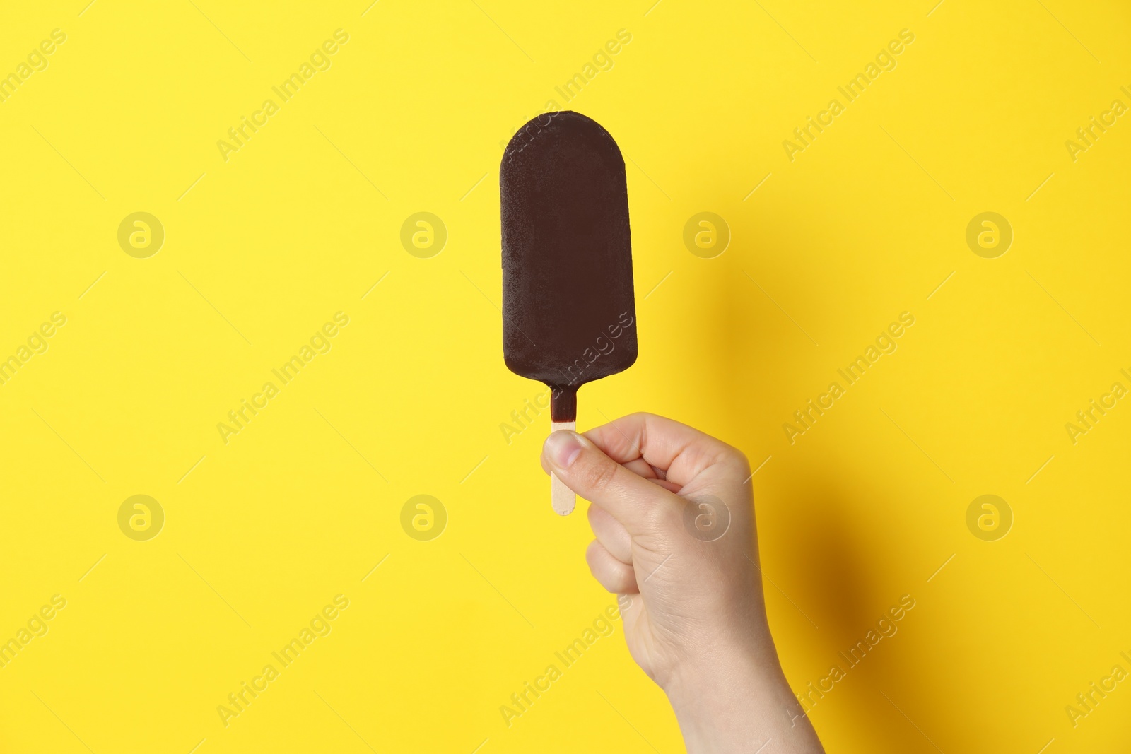 Photo of Woman holding delicious ice cream with chocolate against color background