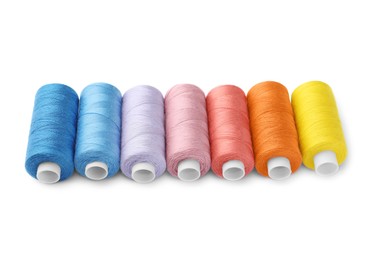 Photo of Set of different colorful sewing threads on white background