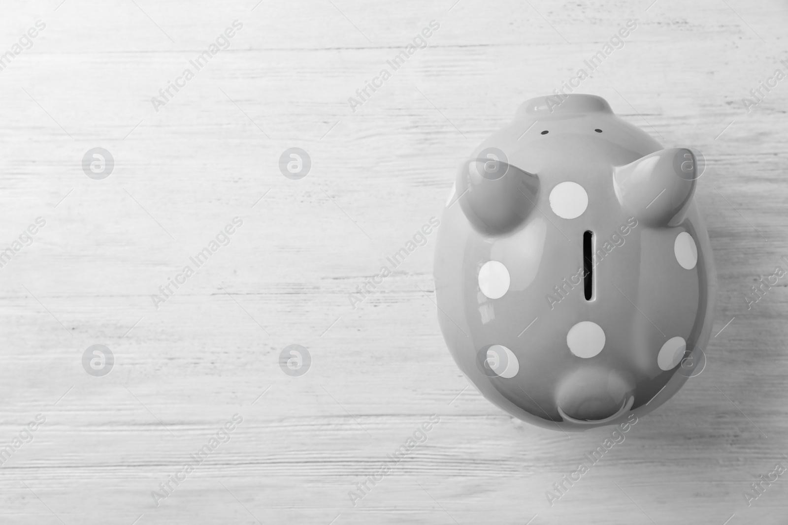 Photo of Gray piggy bank on white table, top view
