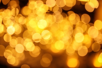 Photo of Gold glitter with bokeh effect on dark background