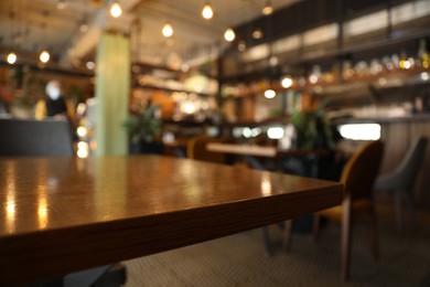 Photo of Stylish modern cafe interior, focus on table. Space for text